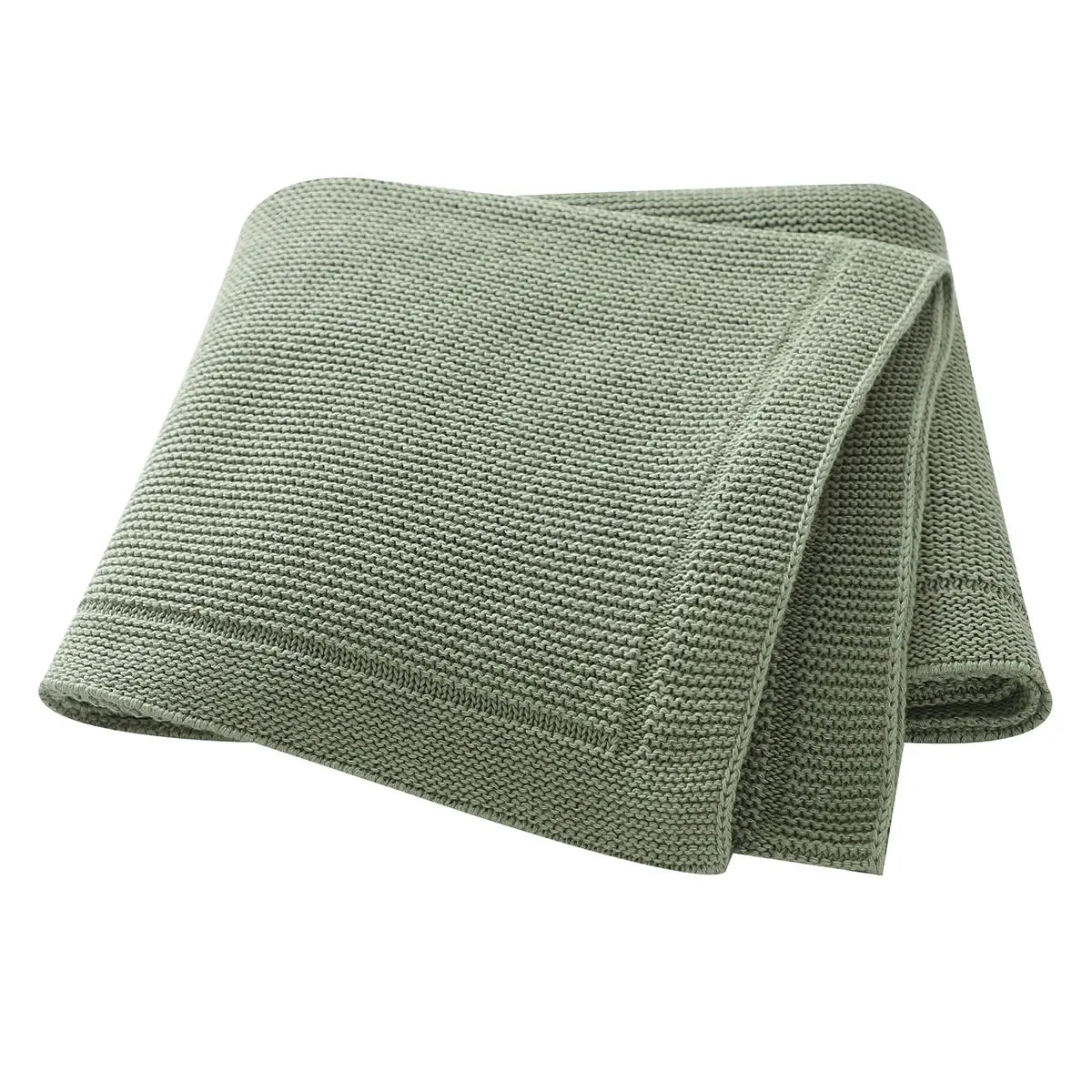 Couverture tricotée bébé GoodKnit en maille douce posée sur un berceau