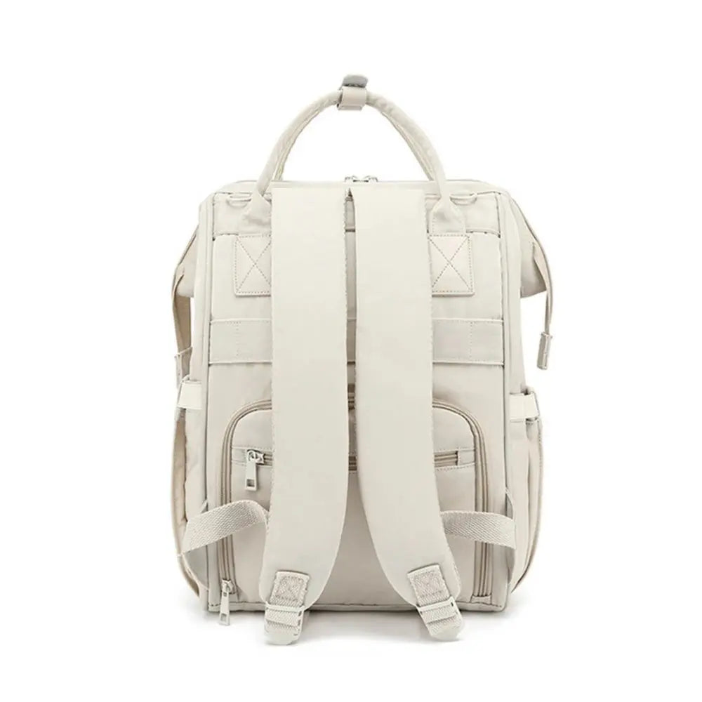 Sac à langer Travel ouvert, compartiments organisés pour biberons, vêtements et couches
